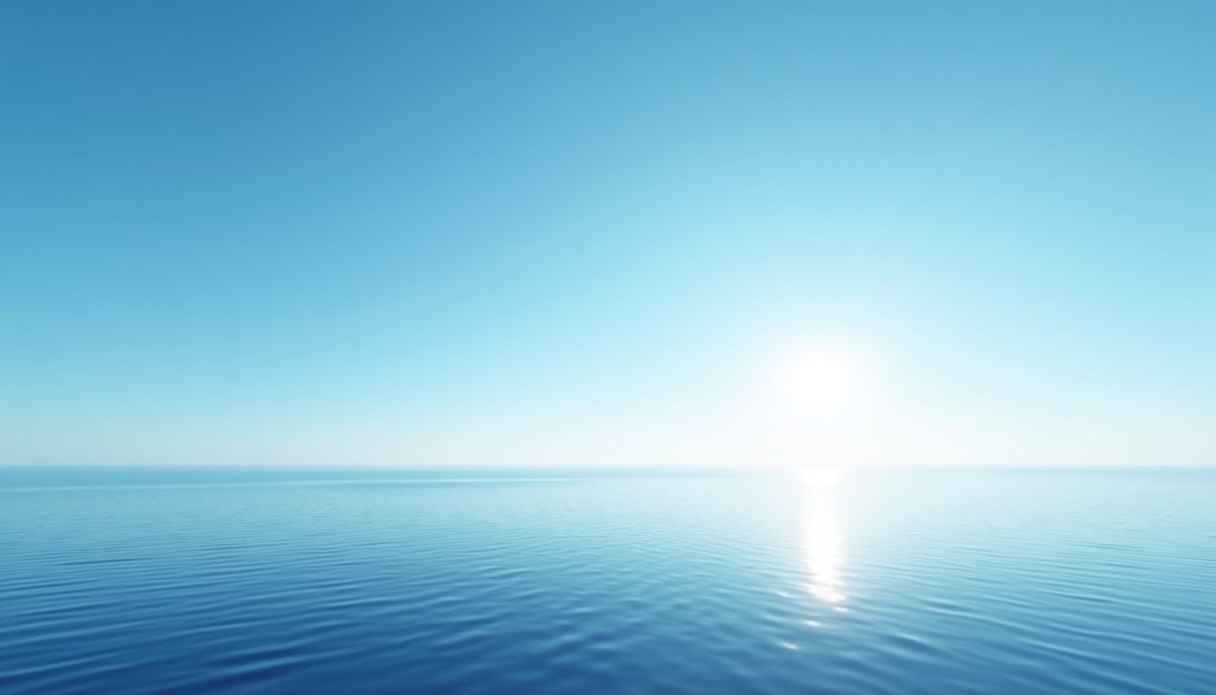 A flat sea horizon at midday, the sky deep blue at the top of the frame grading to pale white at the water